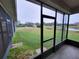 Screened porch with view of backyard and pond at 2912 Sweetspire Cir, Kissimmee, FL 34746