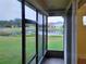 Screened porch overlooking a pond and houses at 2912 Sweetspire Cir, Kissimmee, FL 34746