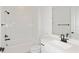 All-white bathroom with a tub and shower combo, plus a sleek vanity with modern fixtures at 5915 Sw 87Th Ave, Ocala, FL 34481