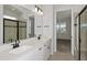 Bright bathroom featuring double sinks, a large mirror, and a shower with a black frame at 5915 Sw 87Th Ave, Ocala, FL 34481