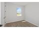 Bright bedroom featuring carpet and a window providing natural light and neighborhood views at 5915 Sw 87Th Ave, Ocala, FL 34481