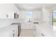 Modern kitchen features sleek white cabinets, stainless steel appliances, and spacious quartz countertops at 5915 Sw 87Th Ave, Ocala, FL 34481