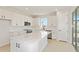 Modern kitchen features sleek white cabinets, stainless steel appliances, and a spacious island with marble countertops at 5915 Sw 87Th Ave, Ocala, FL 34481