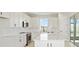 Modern kitchen features sleek white cabinets, stainless steel appliances, and a spacious island with marble countertops at 5915 Sw 87Th Ave, Ocala, FL 34481