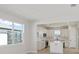 Open-concept living room boasts natural light, modern decor, and seamless flow to the dining area and kitchen at 5915 Sw 87Th Ave, Ocala, FL 34481