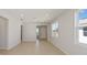 Spacious living room with natural light and neutral tones, featuring tile flooring and smooth walls at 5915 Sw 87Th Ave, Ocala, FL 34481
