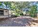 Large backyard with mature trees and a patio area at 613 4Th Ne St, Fort Meade, FL 33841