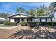House exterior with a covered porch and neatly trimmed hedges at 613 4Th Ne St, Fort Meade, FL 33841