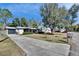 House exterior with a long driveway and mature trees at 613 4Th Ne St, Fort Meade, FL 33841