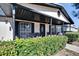 Covered front porch with wicker chairs and brick flooring at 613 4Th Ne St, Fort Meade, FL 33841