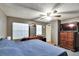Large main bedroom with a king-size bed, dresser, and ceiling fan at 613 4Th Ne St, Fort Meade, FL 33841
