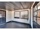 Covered porch with windows and black flooring at 613 4Th Ne St, Fort Meade, FL 33841