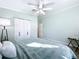 King size bed in a bedroom with light green walls and a ceiling fan at 6330 Oil Well Rd, Clermont, FL 34714