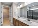 Bathroom with double vanity, modern fixtures, walk-in closet, and a tiled shower at 8707 Sw 57Th Ln, Ocala, FL 34481