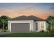 One-story home with gray garage door and landscaping at 8707 Sw 57Th Ln, Ocala, FL 34481