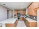 Modern kitchen featuring stainless steel appliances, a center island, and wooden cabinets at 8707 Sw 57Th Ln, Ocala, FL 34481
