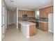 Spacious open kitchen with island, stainless appliances, and warm wood cabinetry at 8707 Sw 57Th Ln, Ocala, FL 34481