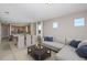 Inviting living room and dining area featuring neutral tones and comfortable seating near the modern kitchen at 8707 Sw 57Th Ln, Ocala, FL 34481
