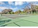 Two tennis courts with green surface and surrounding fence at 2591 Candied Apple Aly, Kissimmee, FL 34744