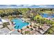 Resort-style pool and expansive deck with palm trees and lounge chairs at 2623 Candied Apple Aly, Kissimmee, FL 34744
