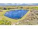 Aerial view of a serene pond surrounded by lush greenery at 2623 Candied Apple Aly, Kissimmee, FL 34744