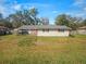 Spacious backyard with a patio area and lush green lawn, perfect for outdoor activities at 5040 Kirkland Rd, Lakeland, FL 33811