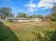 Large backyard with ample green space, storage shed, and playset, perfect for Gathering fun at 5040 Kirkland Rd, Lakeland, FL 33811