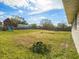 Expansive backyard featuring a wooden playset, mature trees and a wooden fence at 5040 Kirkland Rd, Lakeland, FL 33811