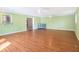 Expansive bonus room with laminate flooring, multiple ceiling fans, and light green walls at 5040 Kirkland Rd, Lakeland, FL 33811