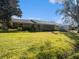 Brick ranch house with a large front yard and landscaping at 5040 Kirkland Rd, Lakeland, FL 33811