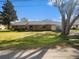 Charming single-story brick home featuring a well-maintained lawn and mature shade trees at 5040 Kirkland Rd, Lakeland, FL 33811