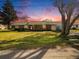 Charming brick home with a well-manicured lawn and mature trees at 5040 Kirkland Rd, Lakeland, FL 33811