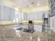 Modern kitchen boasting granite countertops, stainless steel appliances, and ample cabinet space at 5040 Kirkland Rd, Lakeland, FL 33811