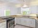Well-lit kitchen showcasing granite countertops, stainless appliances, and views to living area at 5040 Kirkland Rd, Lakeland, FL 33811