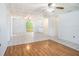 Bright, open-concept living space features tile flooring and updated ceiling fans at 5040 Kirkland Rd, Lakeland, FL 33811