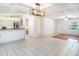 Open living space flows into the kitchen, with modern lighting and bar seating at 5040 Kirkland Rd, Lakeland, FL 33811