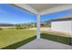 View of a well-manicured backyard and view of other homes in the community from covered porch at 5329 Sw 81St Cir, Ocala, FL 34481