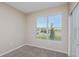 Comfortable bedroom with carpeted floors, a sunny window, and a closet at 5329 Sw 81St Cir, Ocala, FL 34481