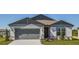 Charming single-story home features a gray exterior, a two-car garage, and a well-manicured lawn at 5329 Sw 81St Cir, Ocala, FL 34481