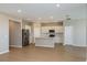 Spacious kitchen with stainless steel appliances, white cabinetry, and a center island overlooking the living area at 5329 Sw 81St Cir, Ocala, FL 34481