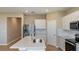 Open-concept kitchen with stainless steel appliances, quartz countertops, and white shaker cabinets at 5329 Sw 81St Cir, Ocala, FL 34481