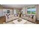 Bright living room featuring neutral tones, modern furnishings, and an open concept layout to the kitchen and dining area at 5329 Sw 81St Cir, Ocala, FL 34481