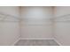 Spacious walk-in closet with carpet floors and wire shelving for optimal storage solutions at 5329 Sw 81St Cir, Ocala, FL 34481