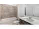 Well-lit bathroom with a tiled shower-tub combination, quartz countertops, and modern vanity at 8223 Sw 52Nd Lane Rd, Ocala, FL 34481