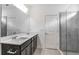 Modern bathroom features a double sink vanity with quartz countertops and a glass-enclosed shower at 8223 Sw 52Nd Lane Rd, Ocala, FL 34481