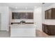 Bright kitchen featuring an island with sink, stainless steel appliances, gray cabinets, and tiled backsplash at 8223 Sw 52Nd Lane Rd, Ocala, FL 34481