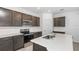 Bright kitchen featuring an island with sink, stainless steel appliances, gray cabinets, and tiled backsplash at 8223 Sw 52Nd Lane Rd, Ocala, FL 34481