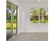 Bright living room with sliding glass doors leading to the backyard, next to a large window at 8223 Sw 52Nd Lane Rd, Ocala, FL 34481