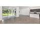 Spacious open floor plan showcasing the living room, kitchen with island, and access to the patio at 8223 Sw 52Nd Lane Rd, Ocala, FL 34481