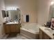 Bathroom with corner tub, double vanity, and tile floor at 2948 W Cottage Grove Ct # Ge, Orlando, FL 32822